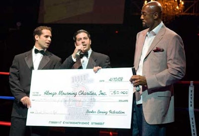 Event planners Robert Sena and David Goldberg presented Alonzo Mourning with a $250,000 check for his charity.