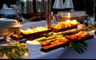 Mena Catering created a Latin-inspired buffet adorned with reeds and other tropical greenery.