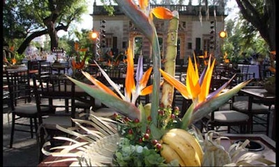 The outside tables were topped with centerpieces of exotic flowers set in upturned straw hats.