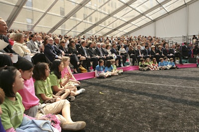 Stadium seating in a clear-roof tent accommodated the guests, among them politicians, hospital board members, and community children.