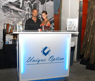 Potions in Motion served drinks from a portable bar branded with the Unique Option logo.