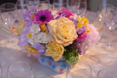 The tables featured ceramic baby-shower-themed containers stuffed with pastel spring flowers.