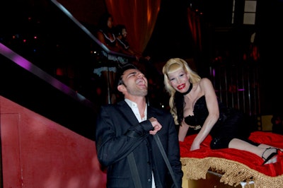 Amanda Lepore sat atop a red velvet pillow and welcomed guests.