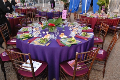 Purple linens echoed the invitation, while exotic-flower centerpieces evoked a jungle setting.