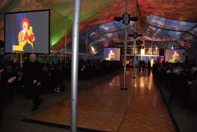 Overize screens hanging throughout the dinner tent allowed diners to get an up-close glimpse of the keynote speech and live auction.