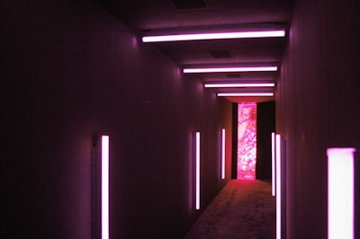 Pink neon light tubes illuminated the winding hallways that led guests into the party.