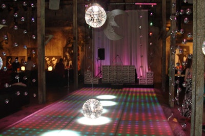 Strings of disco balls surrounded the dance floor, which was lit from below with multicoloured lights.