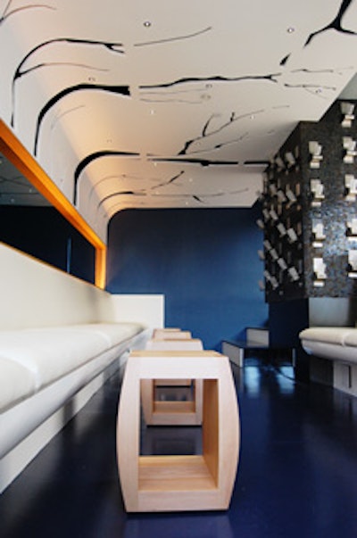 Accents in the loft include white banquette seating and tree-shaped cutouts in the walls.