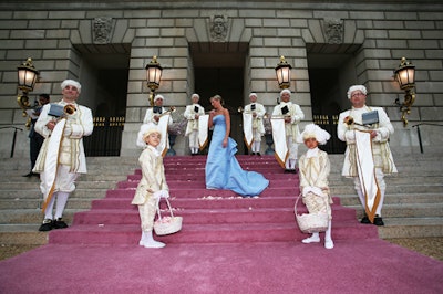 Guests entered on a pink carpet, flanked by trumpeters and two eight-year-old boys dressed as footmen.