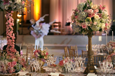 Roses wrapped the bases of the five-foot-tall floral arrangements, which featured sweet pea, cherry blossoms, and hydrangeas.