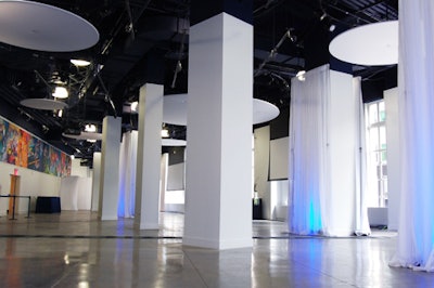 On the second floor, the main event space has polished concrete floors and white columns and is rigged with lighting equipment.