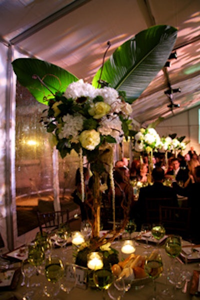 High floral centerpieces on each table appeared to sprout butterfly wings.