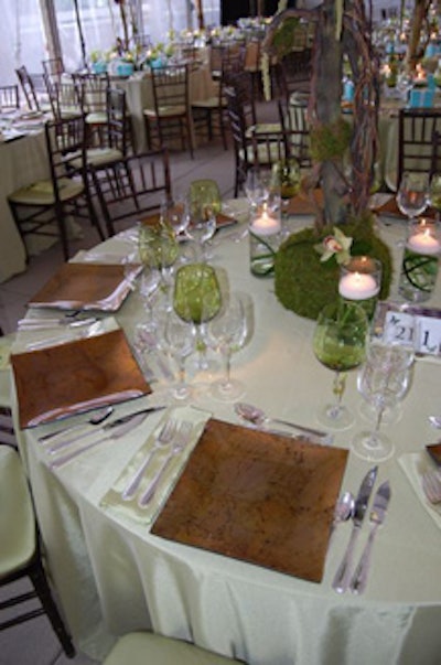 Green linens and wine glasses, plus moss-and-floral centerpieces, created an earthy environment.
