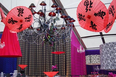 More than 150 suspended elements, ranging from Chinese lanterns to black chandeliers, dangled from the tent's ceiling.