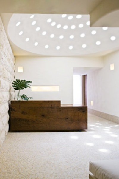 The spa's entrance has a pierced dome ceiling, which allows in dots of natural light.