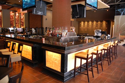 A black granite bar with lit-up panels surrounds a 16-foot waterfall in the centre of the room.