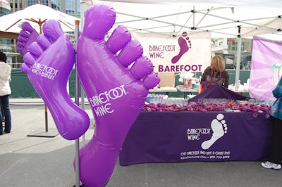 The wine company's blown-up barefoot logo provided a backdrop while staffers handed out purple leis and keychains to passersby.