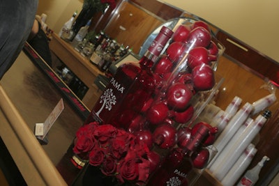 In Touch party sponsor Pama Pomegranate Liquor filled tall glass vases on the bars with pomegranates.