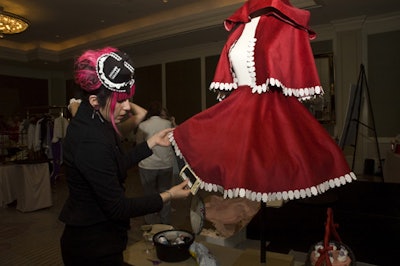Vedika Webb of Philadelphia's Lotus Cake Studio put the finishing touches on her Little Red Riding Hood costume.