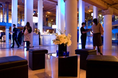 Small lounge areas offered seating on black leather stools clustered around flower-topped tables.