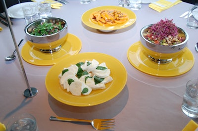 Plates of haricots verts salad, chopped vegetable salad, and buffalo mozzarella sat atop each dining table.