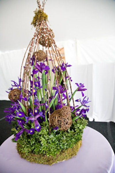 The prelunch reception area included three-foot-tall birdcage-esque arrangements of irises, moss, and pussy willows.