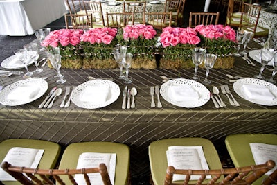 The centerpieces evoked an English garden with structured tiers of roses and moss, fenced by pussy willows.