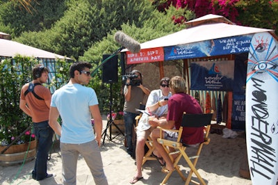 Journalists interviewed Laird Hamilton in front of one of the Paradise Cove cabanas.