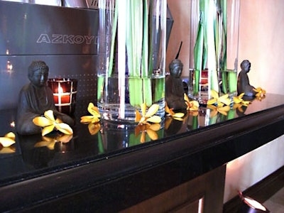 Mini Buddha statues and orange orchids decorated the bar in the dining room.