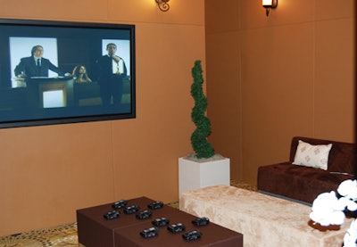 Attendees can put on wireless headsets in a mini theater, where videos highlight the company's marketing campaign and design methods.