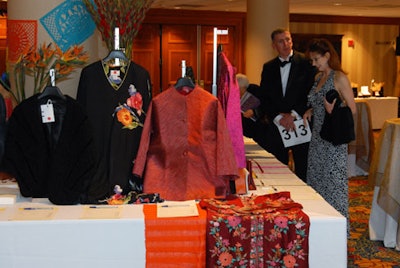 The predinner silent-auction area showcased paper flags and tropical centerpieces reminiscent of a Mexican market.