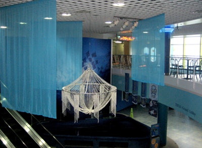 A crystal bead chandelier set amid turquoise voile fabric panels added sparkle to the venue's lower lobby.