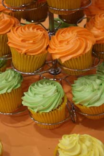 Cupcakes in citrus hues were arranged on tower displays, courtesy of Apple Spice Junction Catering.