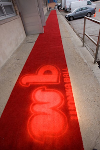 Reality TV stars, including Project Runway's Steven Rosengard and Top Chef's Dale Levitski, posed on a red carpet illuminated with the Wonka Ball logo.