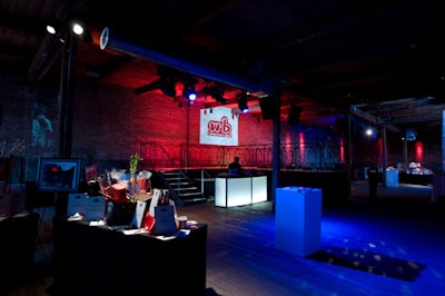 Remer used the stage as a space divider, flanking it with silent auction tables and lit-up bars.