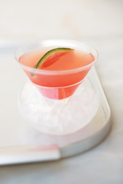Summer fruit orchard, with vodka, orange liqueur, watermelon juice, mango juice, grenadine, and a watermelon slice, from Wolfgang Puck Catering.