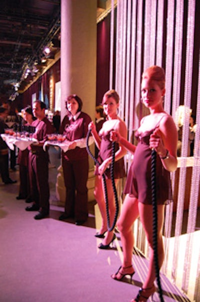 Models dressed in black greeted guests at the entrance to the main room.