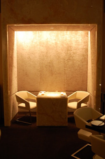 A crushed-velvet-lined alcove along one wall of the main dining room houses a white onyx table for two.