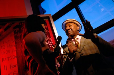 Event chair Kenneth Montague spoke to a reporter in front of a mirror listing the evening's performances.