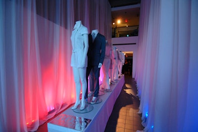 White drapes, coloured lighting, and a runway featuring mannequins in Hugo Boss clothing decorated the main hall gallery.