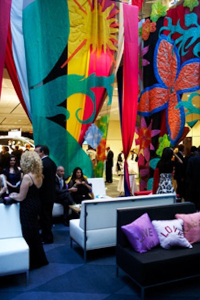 Panels of colourful fabric hung from the ceiling in the lounge area, where pillows embroidered with Anna Maria de Souza's motto—'Live, Love, Laugh'—topped sofas.