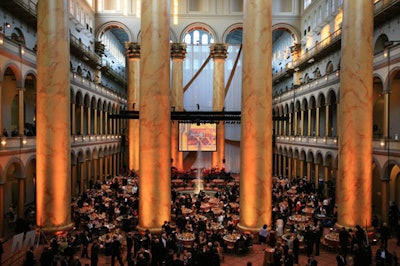 A giant sheer white curtain, decorated with draped sashes, acted as the stage backdrop.