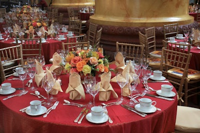 The sun-kissed settings' colors—pink, red, and yellow (including multicolored roses and orchids in gold bowls from Jack Lucky)—matched the venue's overall decor.