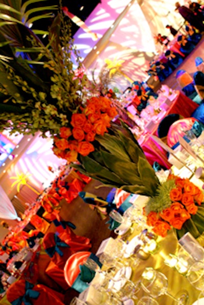 The larger centerpieces featured palm fronds and were placed atop the tables along the perimeter of the space to create the appearance of a forest within the pavilion.