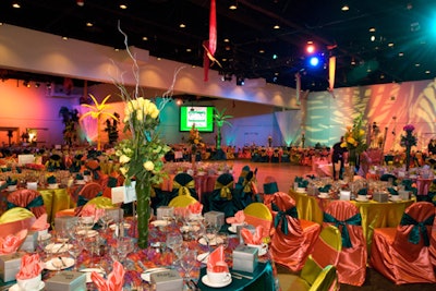 Tables were clad in satin linens in a multitude of color combinations from coral and chartreuse to teal and gold topped with centerpieces of varying sizes and colors.