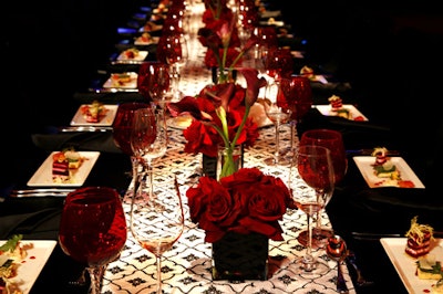 Red flower arrangements and wineglasses added splashes of color to tabletops.