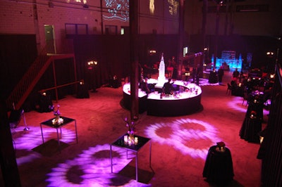 Cocktail tables draped in black PVC fabric, pink floral arrangements, and two New York-themed ice sculptures filled the venue.