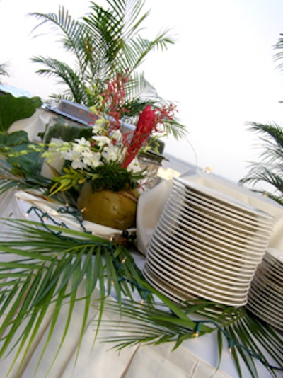 Food stations decorated with palms and tropical foliage added to the Latin-themed decor.