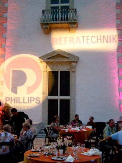 Soft orange and purple lighting glowed company names on the villa's walls.