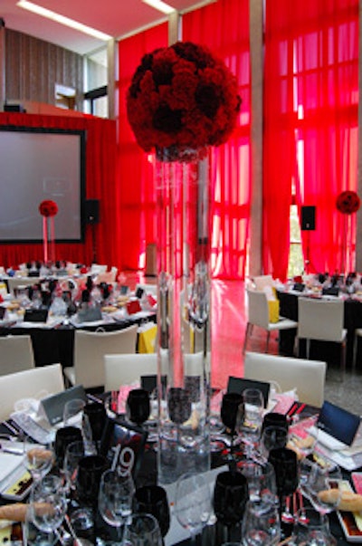 Balls of red roses topped tall tubular glass vases in the centrepieces created by San Remo Florist.